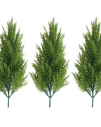 Three artificial pine trees without pots, side by side