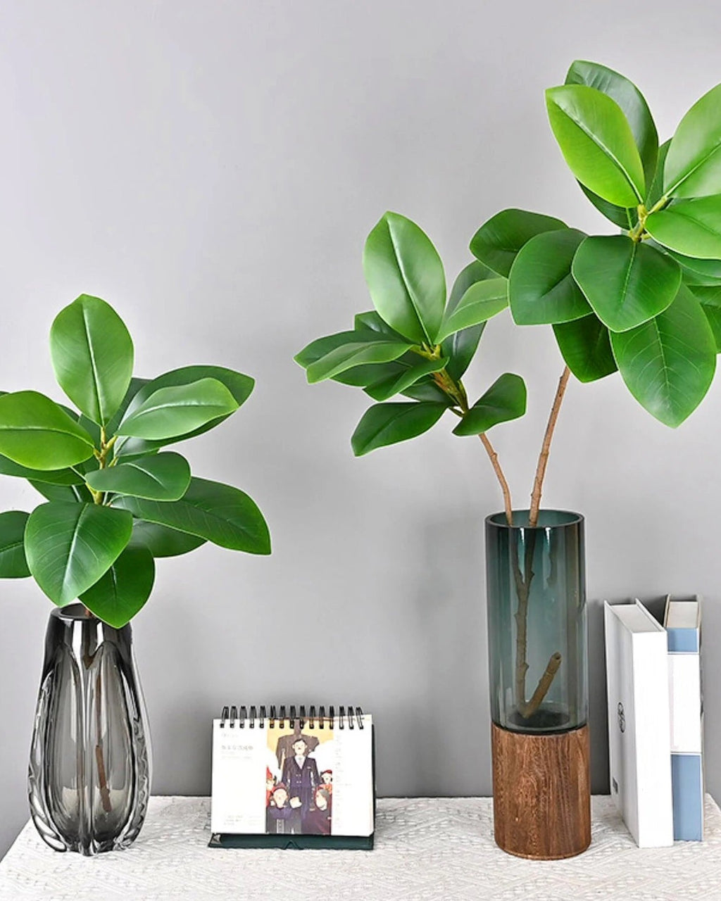 Artificial tree branches standing in glass vases on a shelf; no vase is included