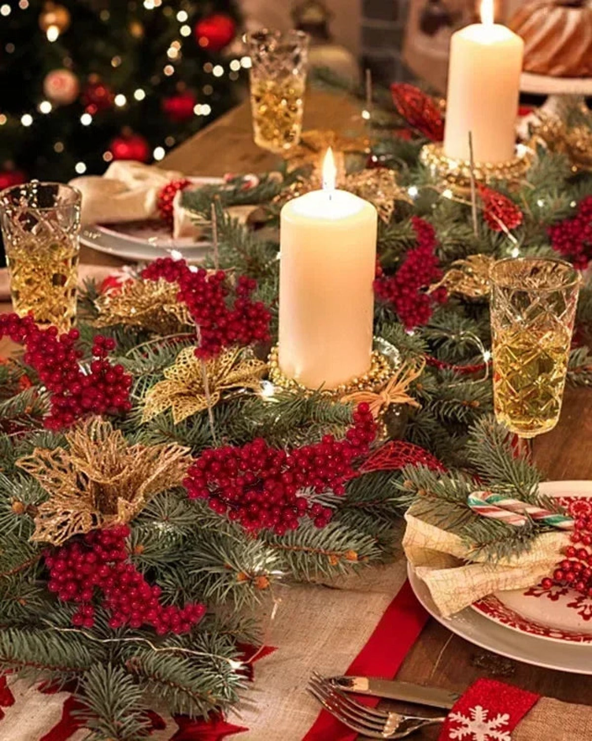 Artificial berry branches worked into a Christmas table setting; only the berry branches are part of the order