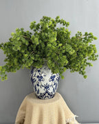 Several artificial pine branches arranged in a patterned jar; each order is one branch, and no vase is included