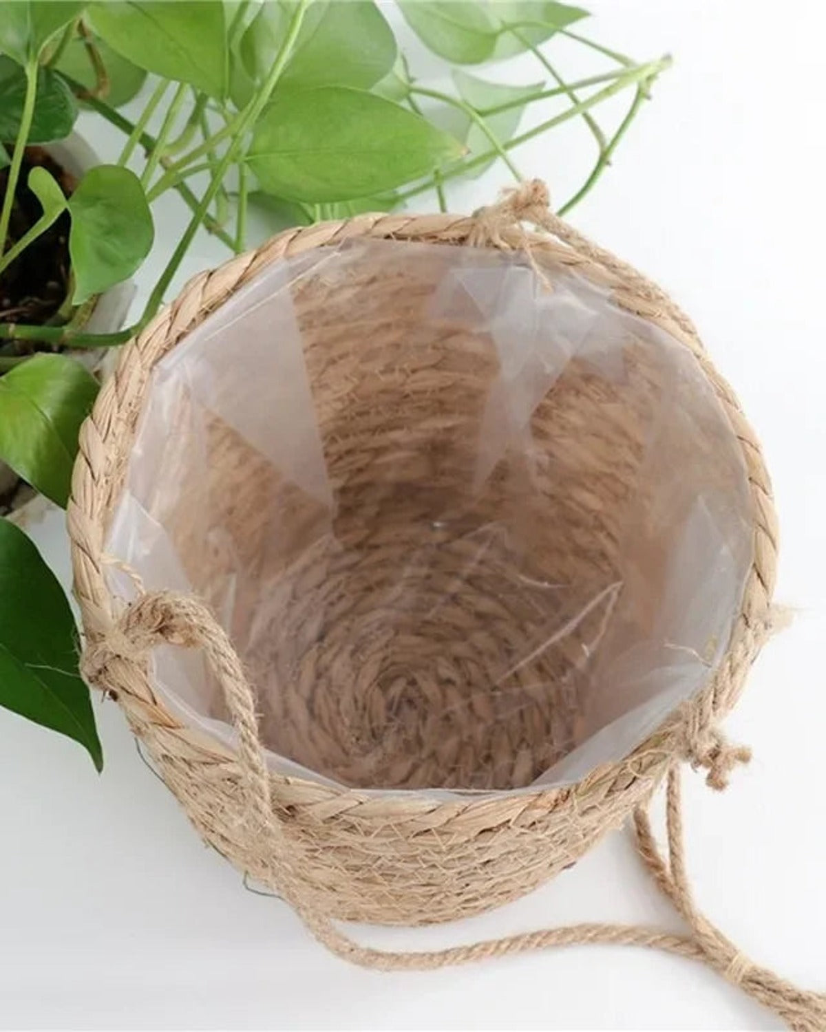 The clear waterproof liner inside the woven hanging plant basket