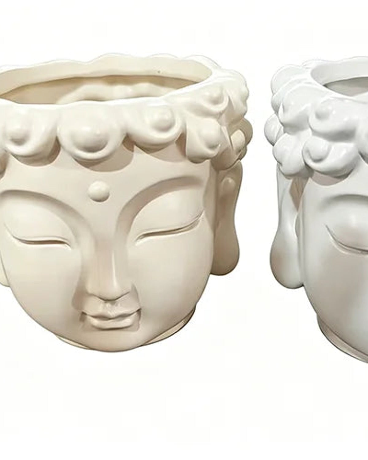 The cream and the white Buddha head planters side by side, both empty