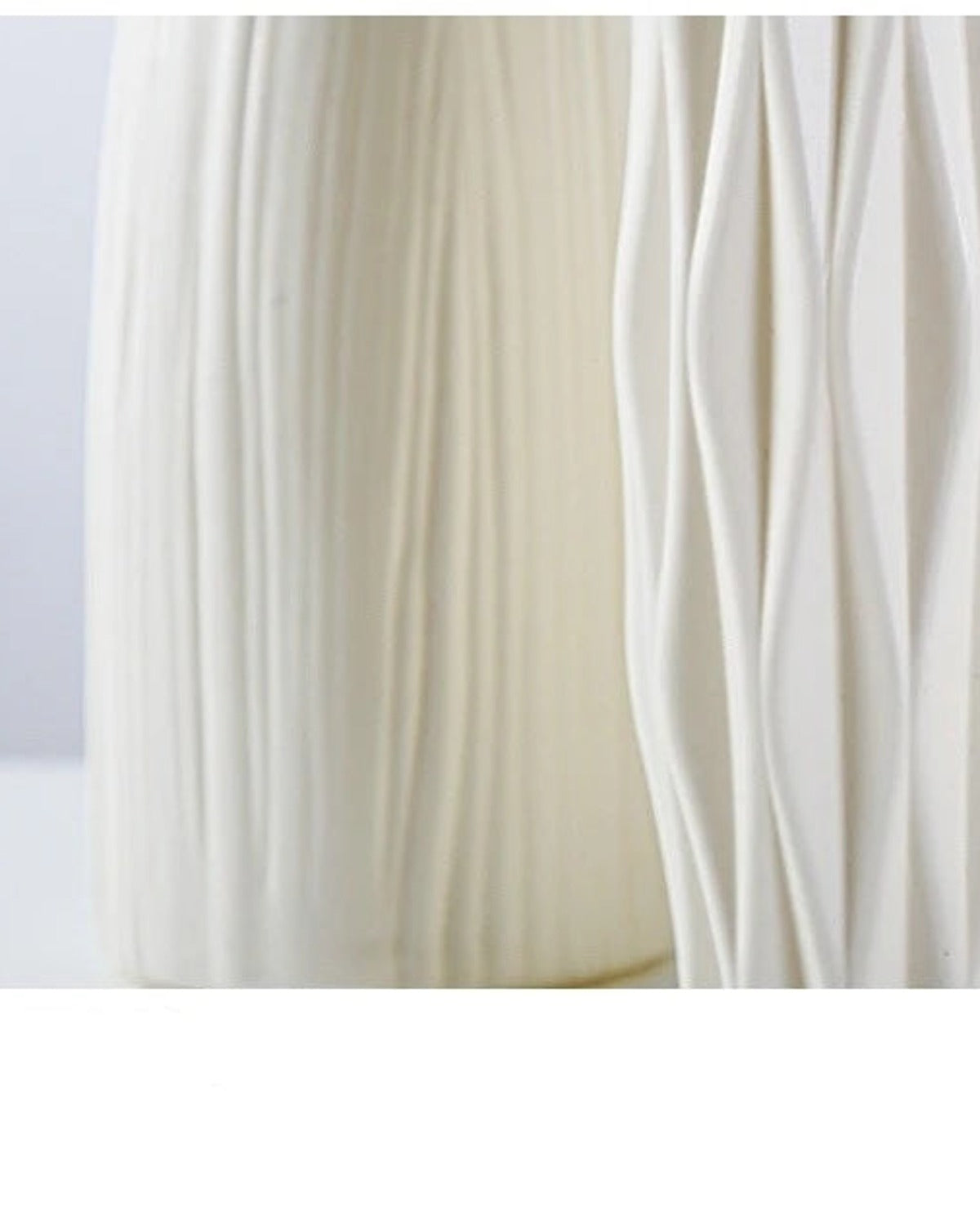 A close look at the molded surface of the white origami vase