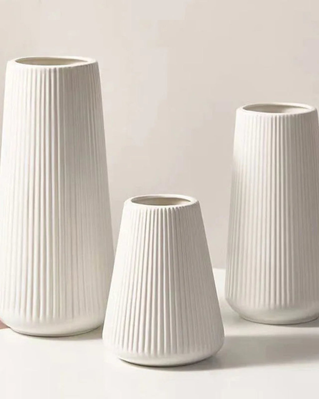 The three sizes of the fluted tapered vase standing empty