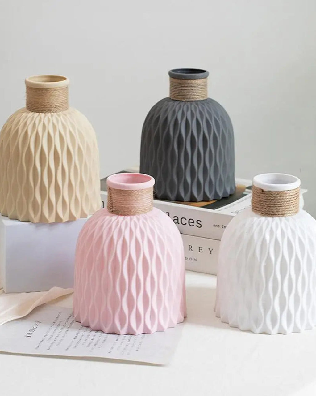 The four colors of the rope neck vase grouped on a tray