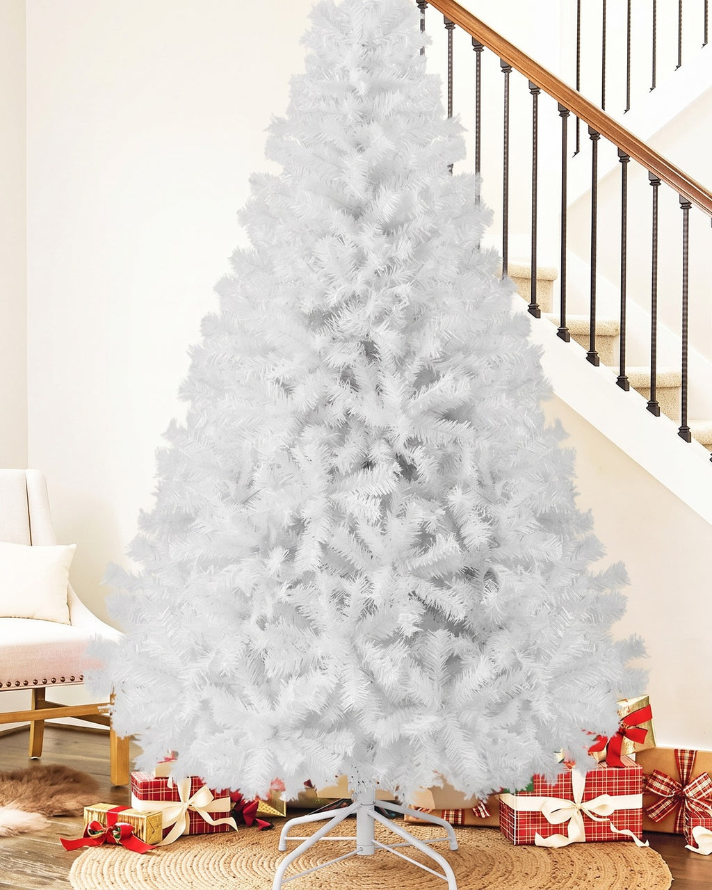 The White tree, undecorated, on its white folding stand at the foot of a staircase; the gifts are not included