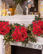 Red poinsettia bouquets along a mantel with a pine garland; garland and mantel decorations not included
