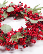 The berry and eucalyptus wreath from a low angle, showing its twig base