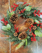 The cypress and pinecone wreath laid flat on stone tiles
