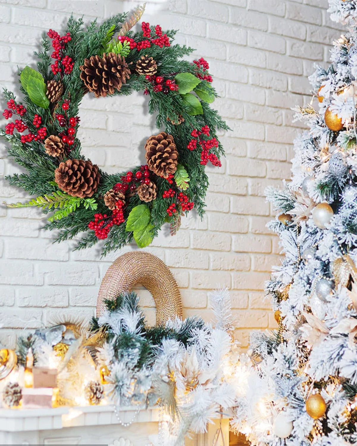 The cypress and pinecone wreath on a white brick wall beside a flocked tree; tree and mantel decorations not included