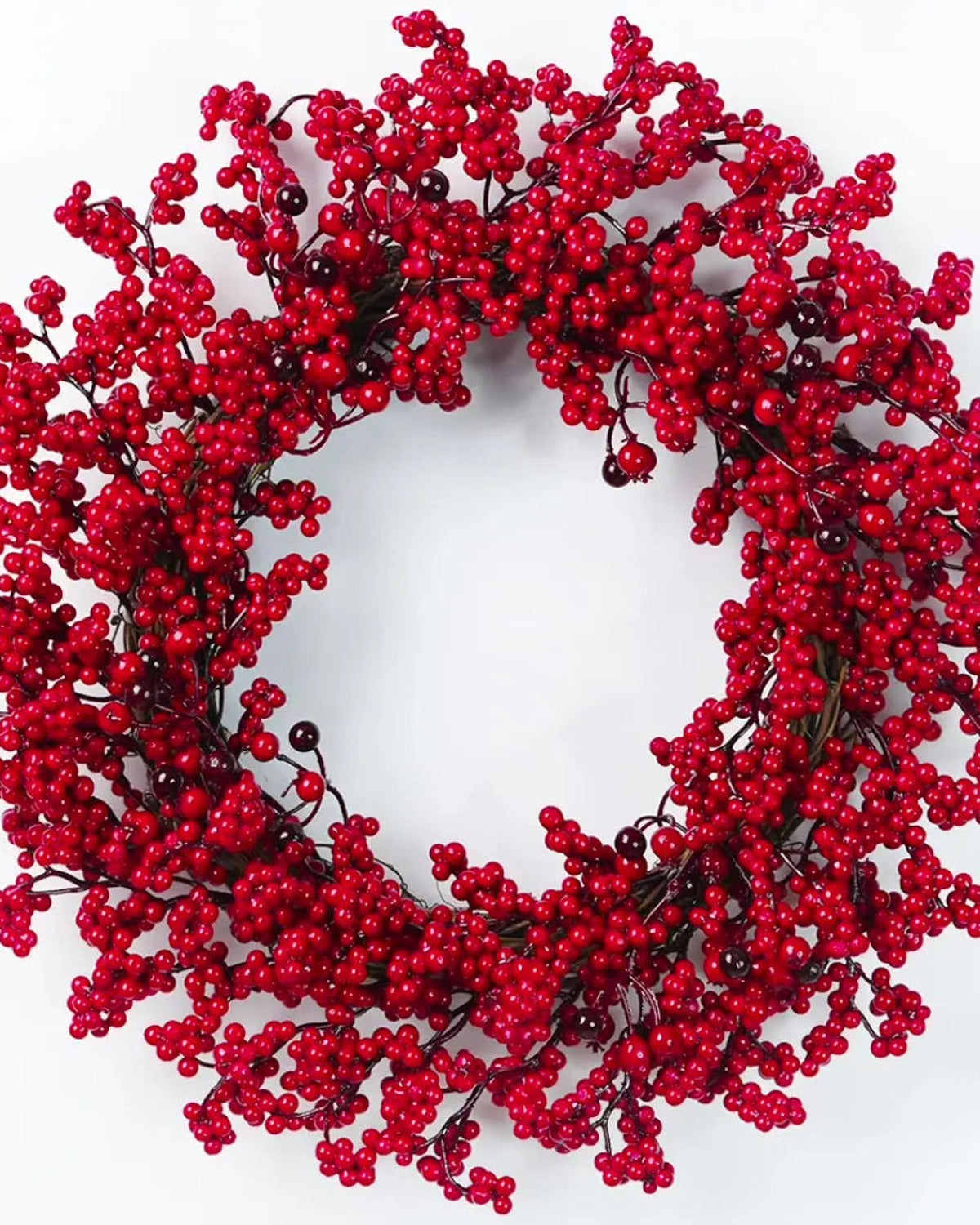 The red berry wreath on a plain white ground, red berries on a twig base with no leaves