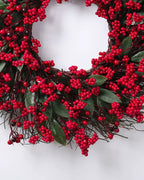 The lower half of the berry and twig wreath, dense red berry clusters over its twig base