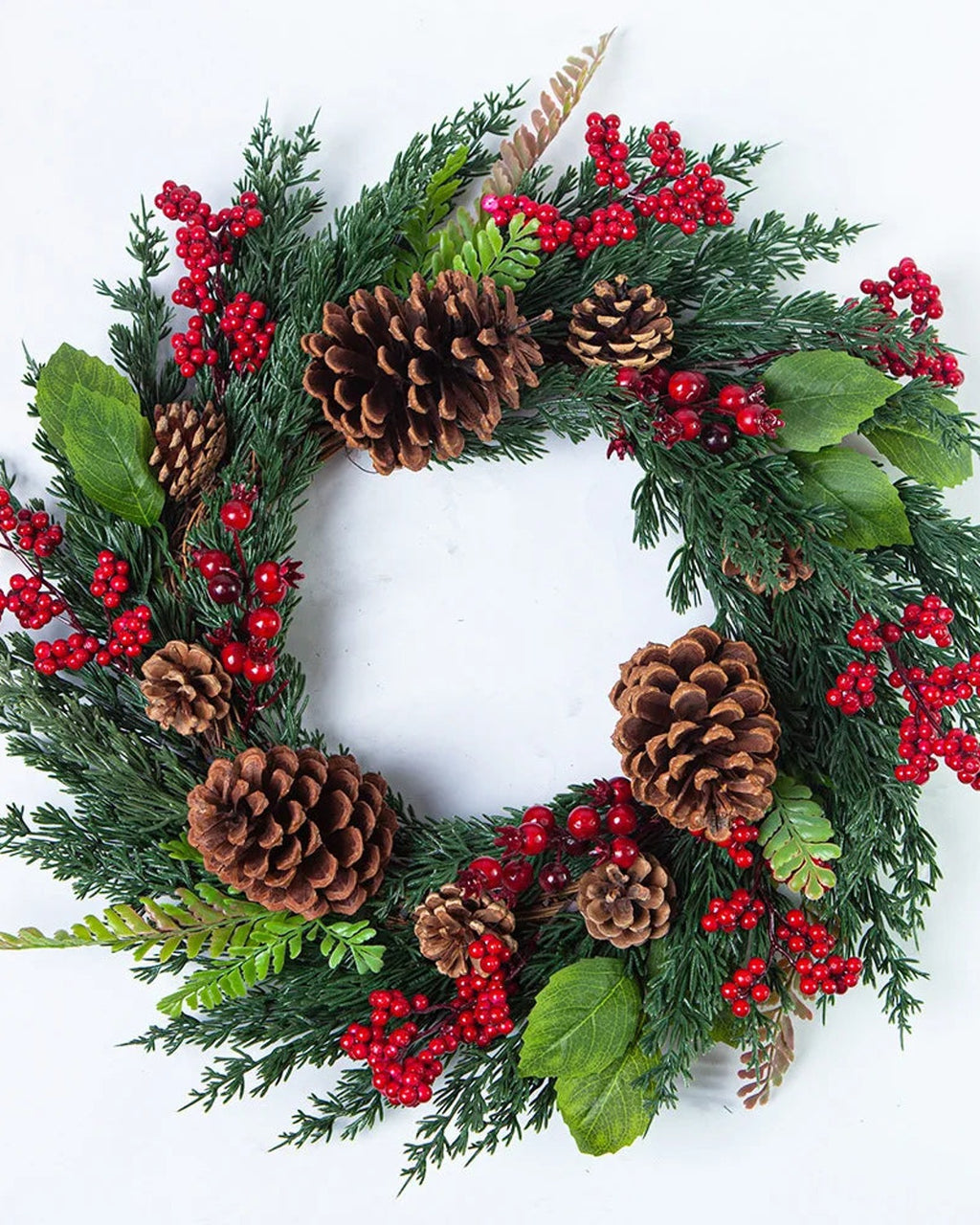 The cypress and pinecone wreath on a plain white ground