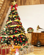 A green spruce Christmas tree dressed with gold ribbon and baubles in a loft room; decorations and gifts not included