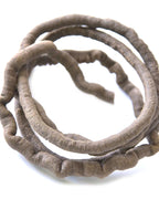 The brown artificial rattan vine coiled loosely on a plain white background