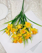 The orange and yellow daffodils laid on lace, one bunch