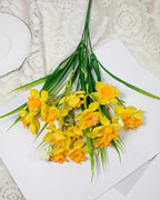 The orange and yellow daffodils fanned out on lace