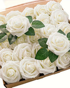Ivory foam rose heads and leaf sprays in an open box, seen from above