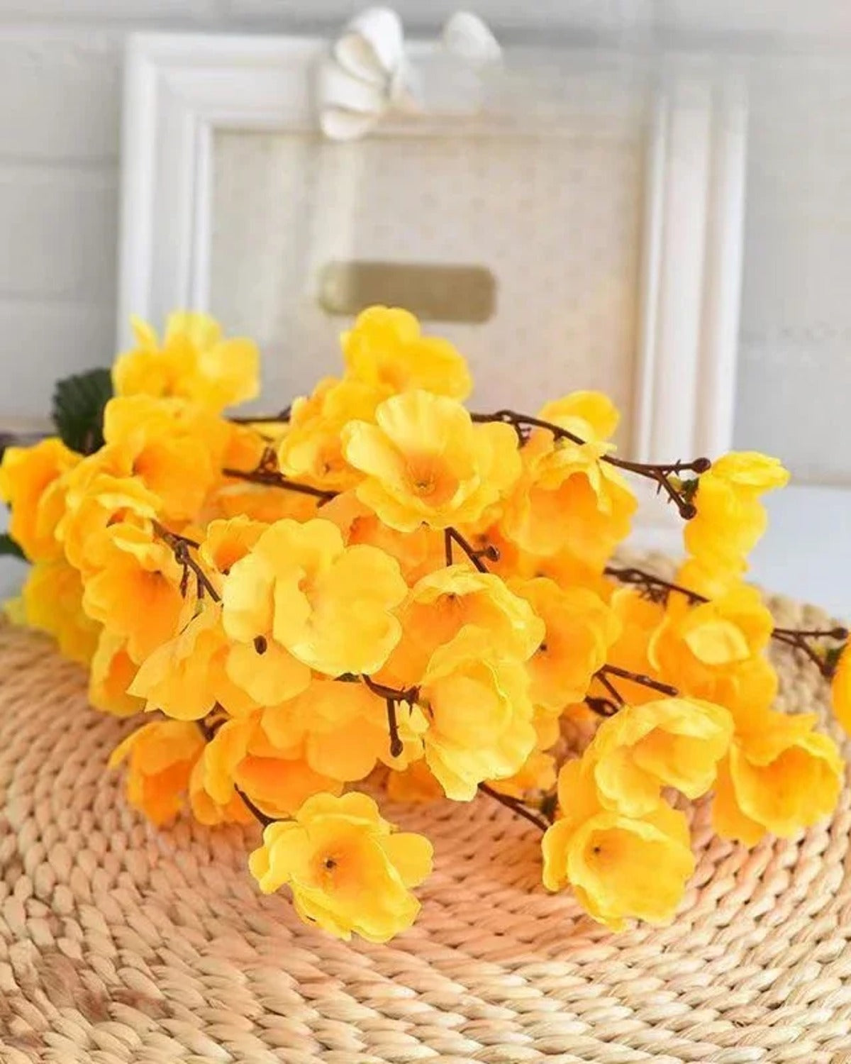 Yellow peach blossom laid on a woven mat, the flowers open along the stem
