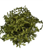 The leaf trim gathered into a dense pile, showing how much is on one coil