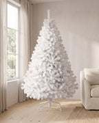 The White tree, undecorated, on its white folding stand in a living room corner beside a tall window