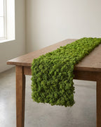 A strip of artificial moss mat running down a wooden table. Table not included; see the size guide for the three lengths.
