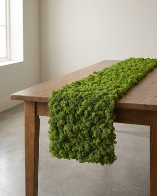 A strip of artificial moss mat running down a wooden table. Table not included; see the size guide for the three lengths.