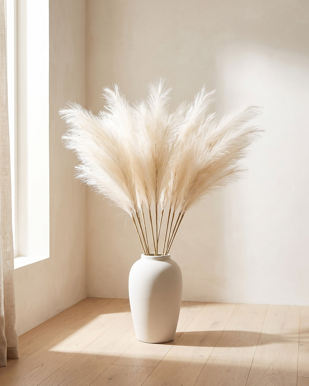 The same pampas arrangement in the corner of a bare sunlit room