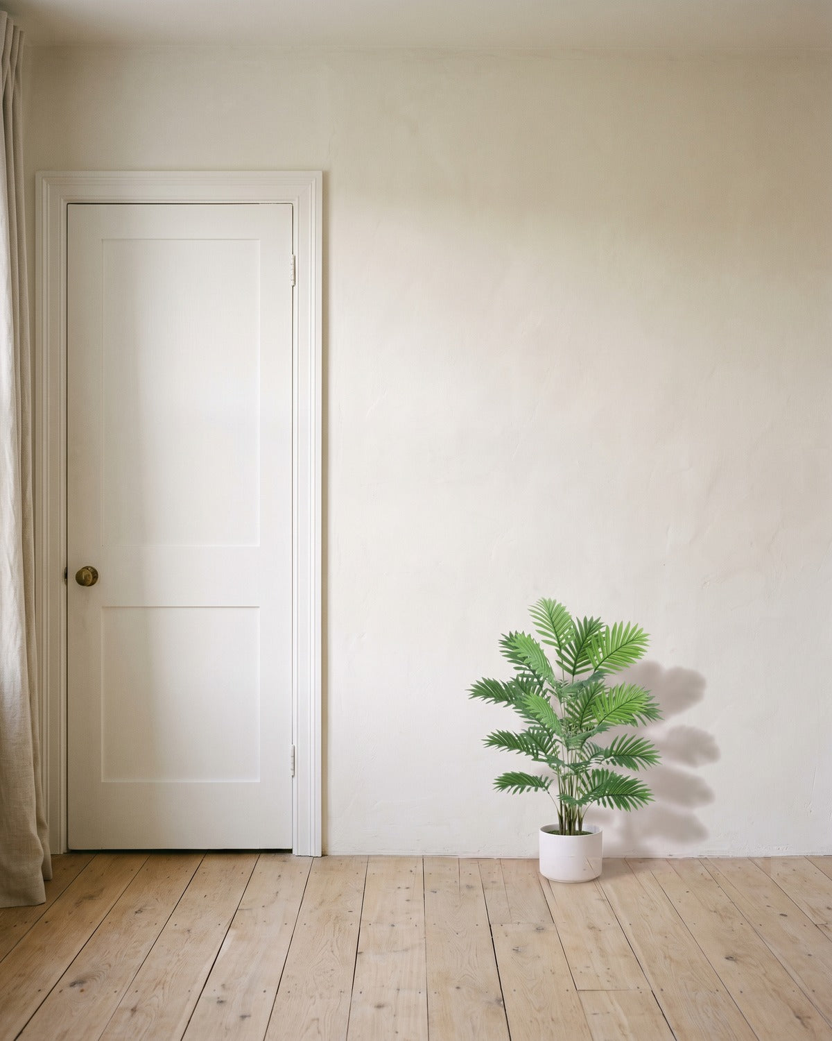 An artificial areca palm with eighteen fronds, 32 in tall, in a plain white pot beside an 80 in door to show its height; pot not included