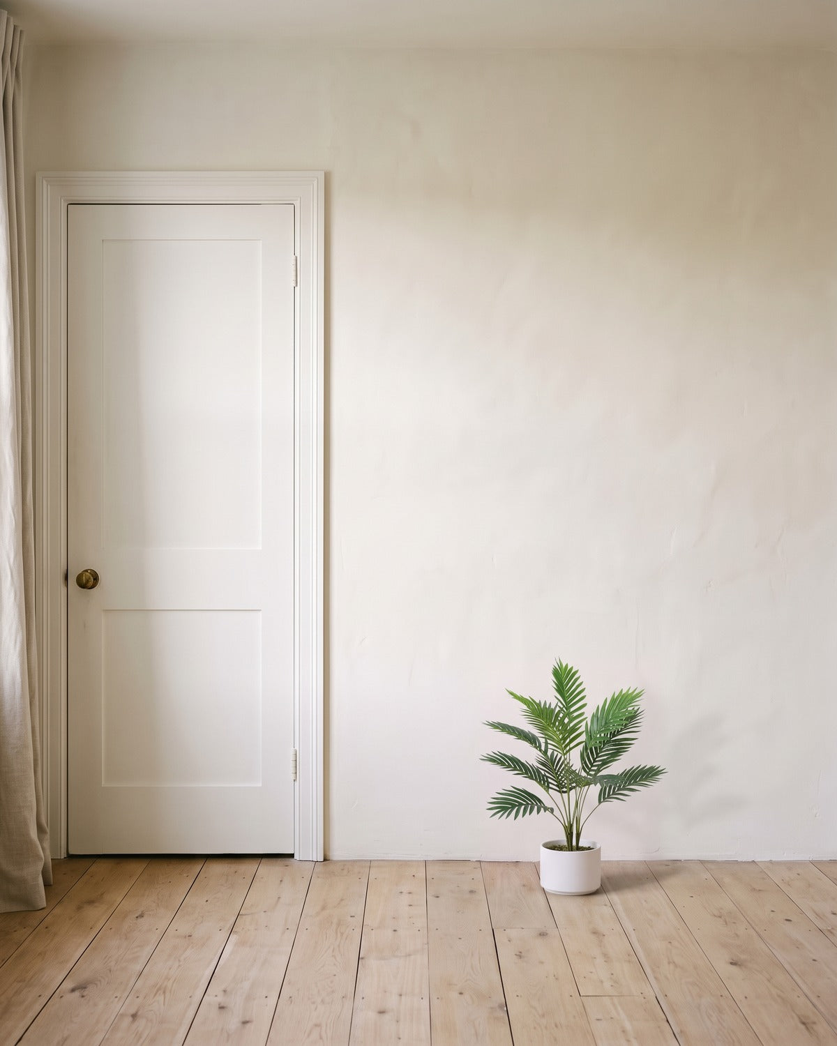 An artificial areca palm with twelve fronds, 26 in tall, in a plain white pot beside an 80 in door to show its height; pot not included