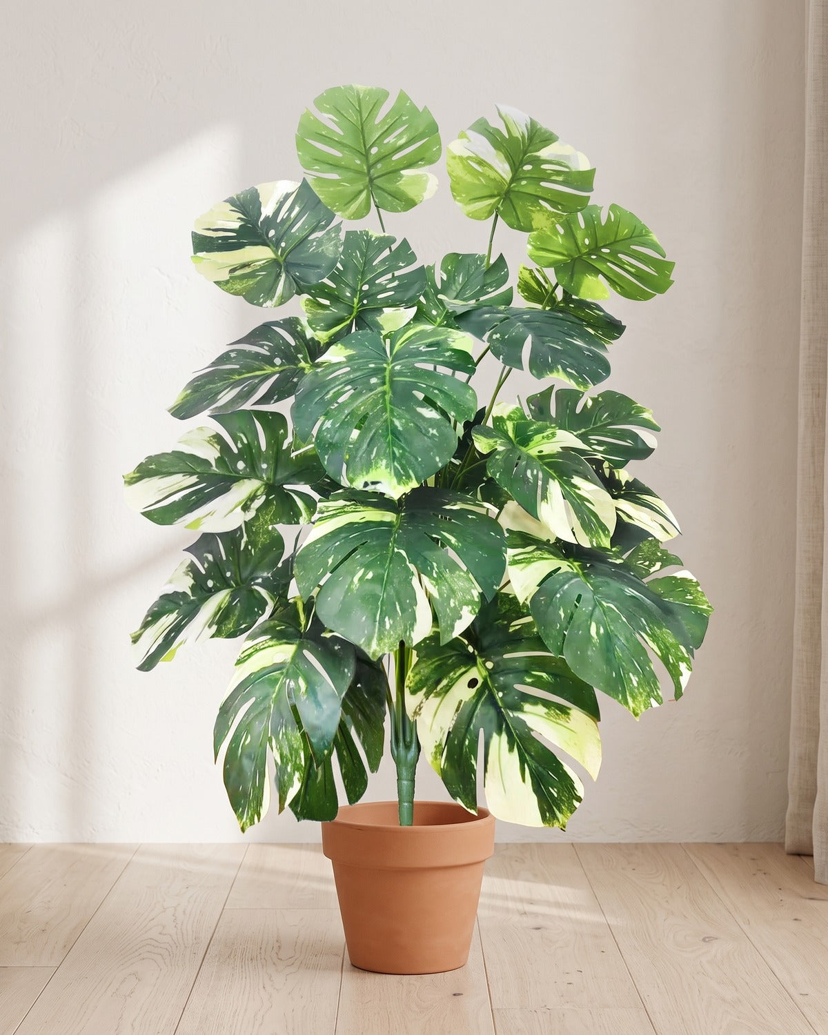 Variegated split leaf artificial leaf bush, 39.4 in with twenty-four leaves, in a plain terracotta pot on pale oak floorboards; pot not included