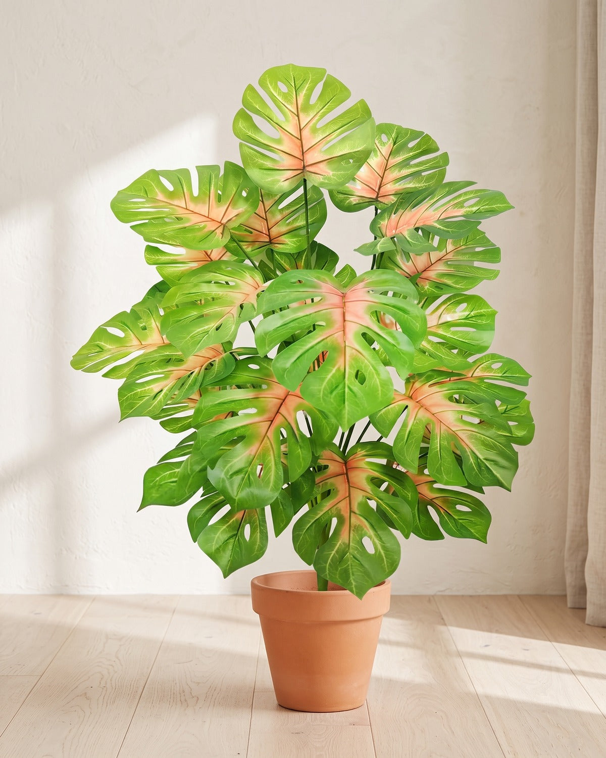Pink-veined split leaf artificial leaf bush, 33.9 in with twenty-four leaves, in a plain terracotta pot on pale oak floorboards; pot not included
