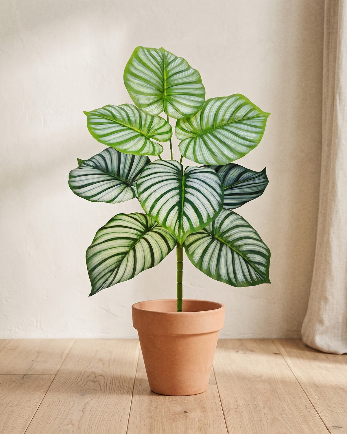 Silver-striped leaf artificial leaf bush, 24.8 in with eight leaves, in a plain terracotta pot on pale oak floorboards; pot not included