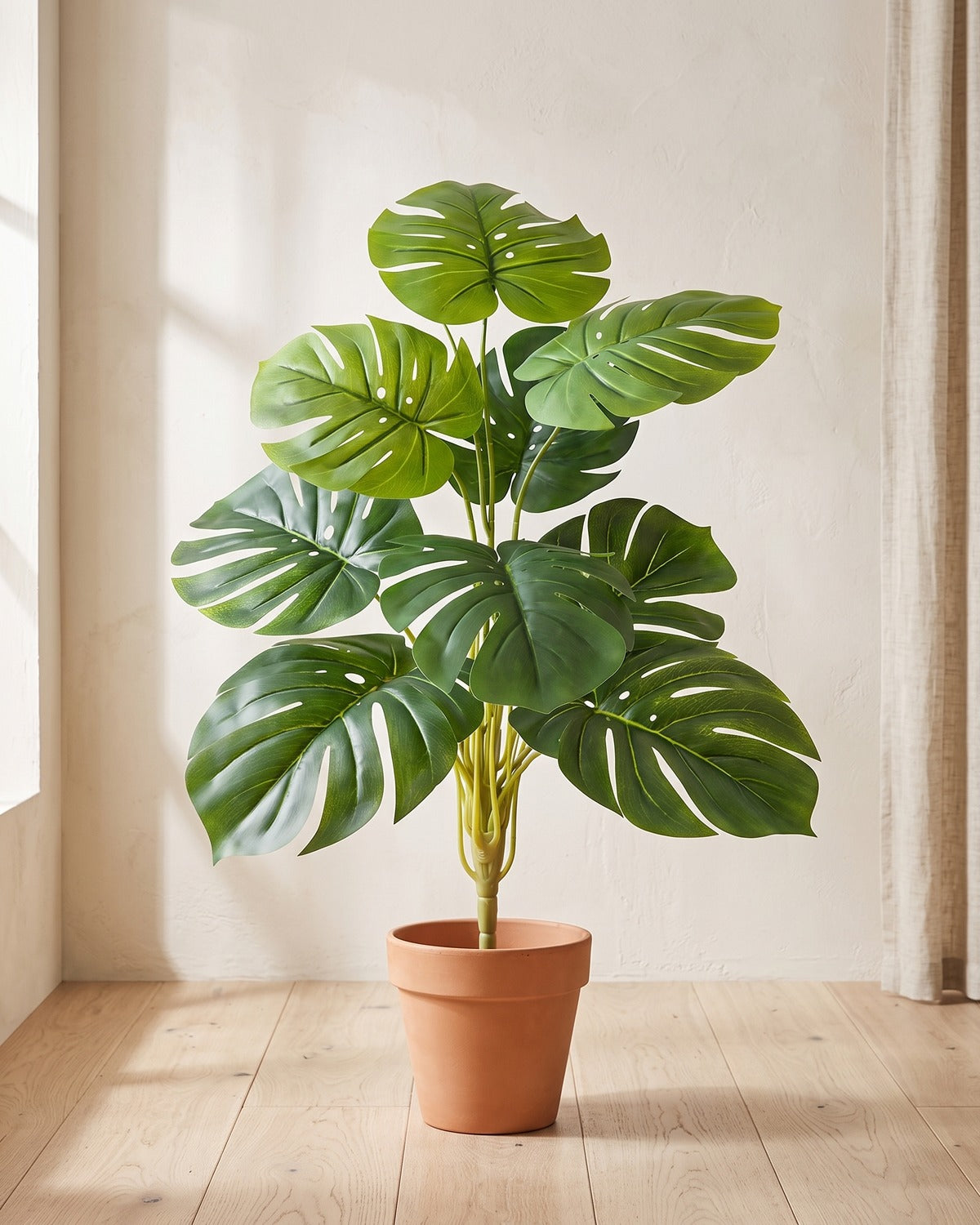 Deep green split leaf artificial leaf bush, 29.5 in with nine leaves, in a plain terracotta pot on pale oak floorboards; pot not included