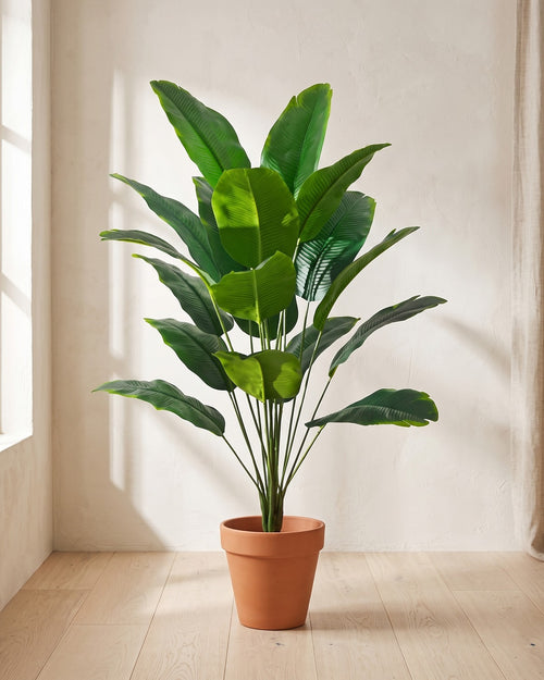 Green leaf artificial banana leaf plant, 32.3 in with eighteen leaves, in a plain terracotta pot on pale oak floorboards; pot not included