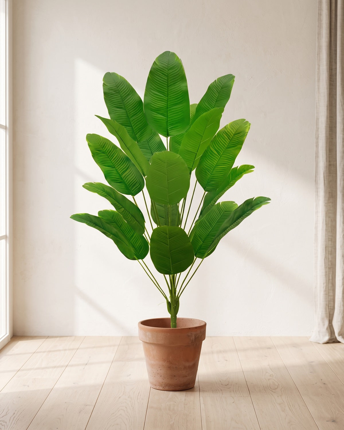 Green leaf artificial banana leaf plant, 47.2 in with eighteen leaves, in a plain terracotta pot on pale oak floorboards; pot not included