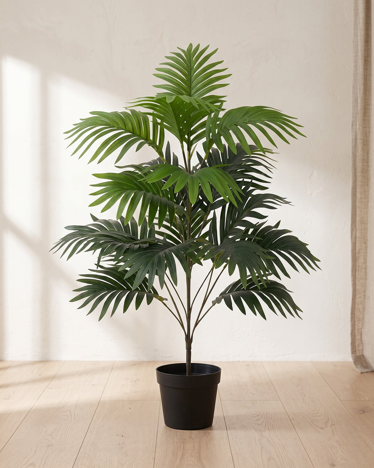 An artificial palm leaf bush with twenty-one fronds, 27.6 in tall, in a plain black nursery pot on pale oak floorboards; pot not included