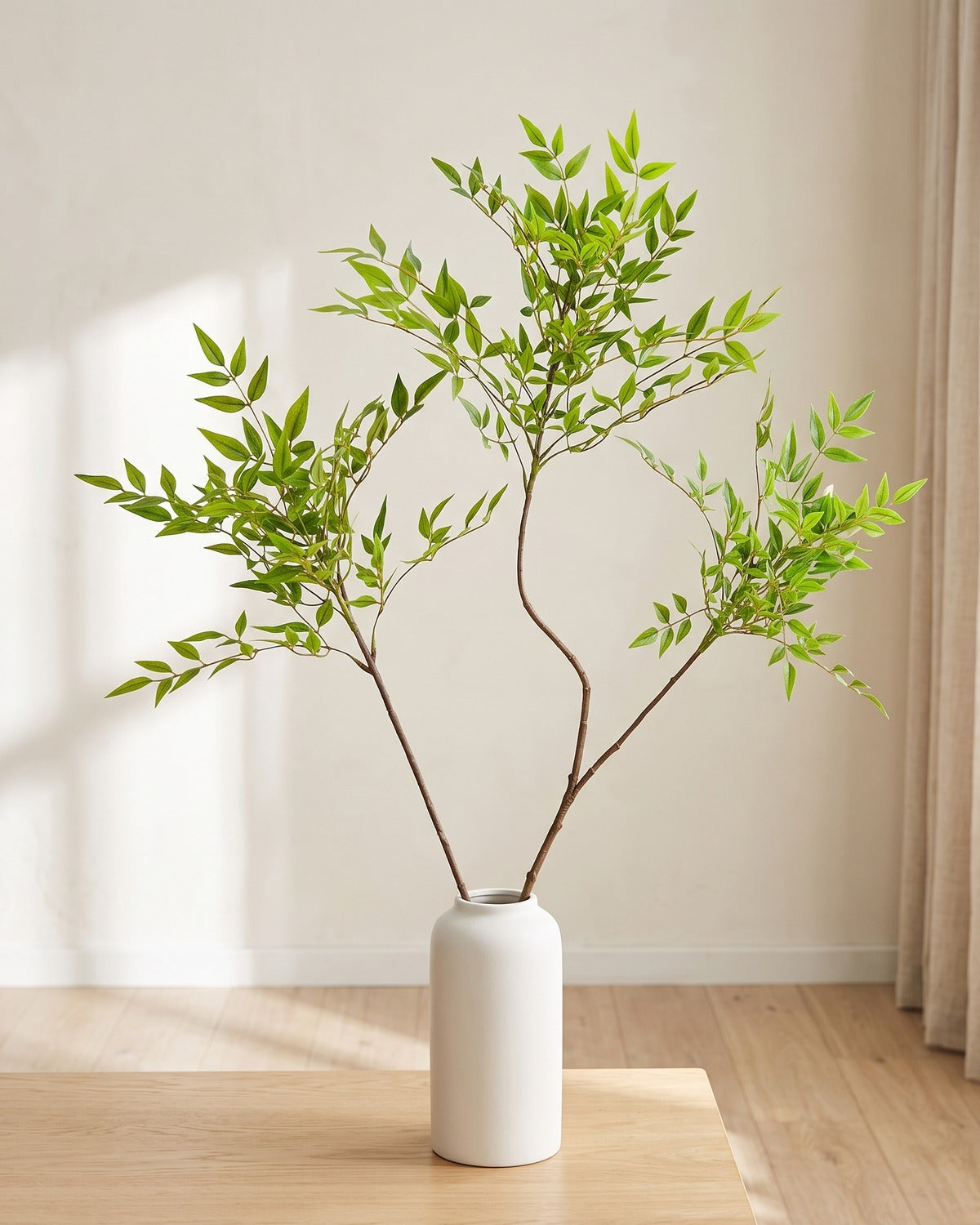 Fine leaf artificial tree branch, set of 2, 43.3 in, standing in a plain white vase on a pale oak table; no vase is included