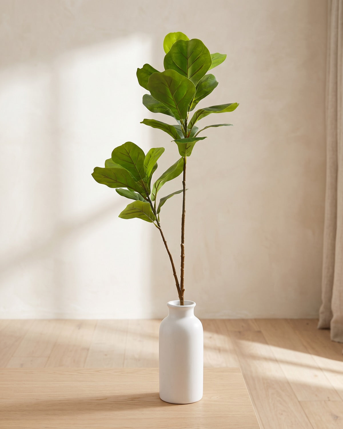 Fiddle leaf artificial tree branch, 22 leaves, 41.3 in, standing in a plain white vase on a pale oak table; no vase is included