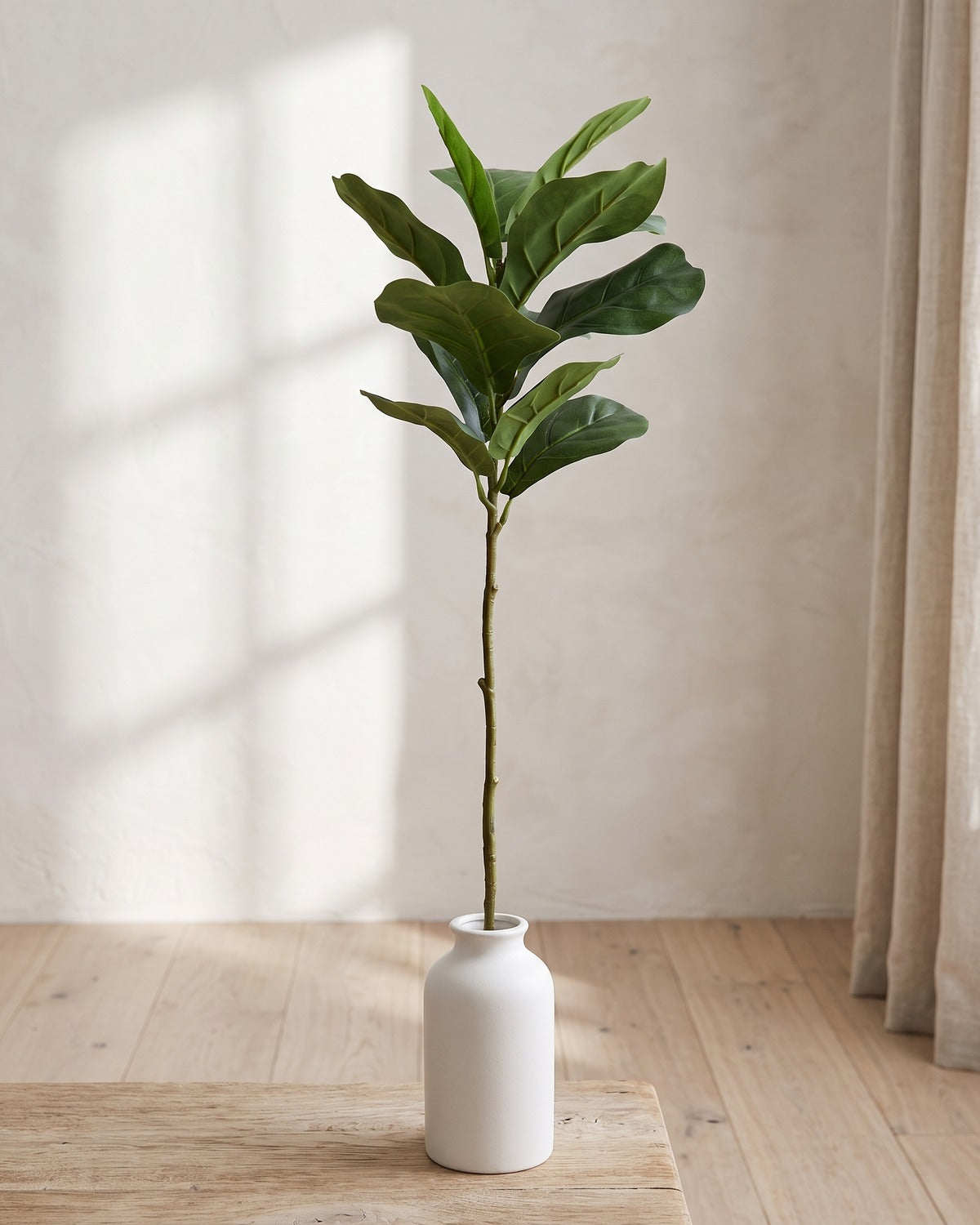 Fiddle leaf artificial tree branch, 13 leaves, 30 in, standing in a plain white vase on a pale oak table; no vase is included