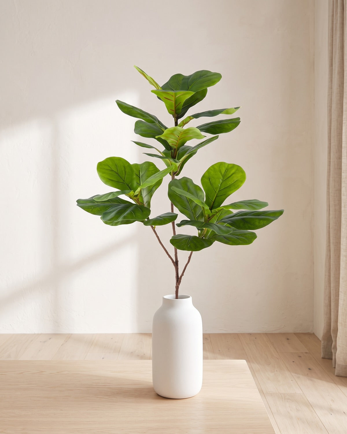 Fiddle leaf artificial tree branch, 3 stems, 53.1 in, standing in a plain white vase on a pale oak table; no vase is included