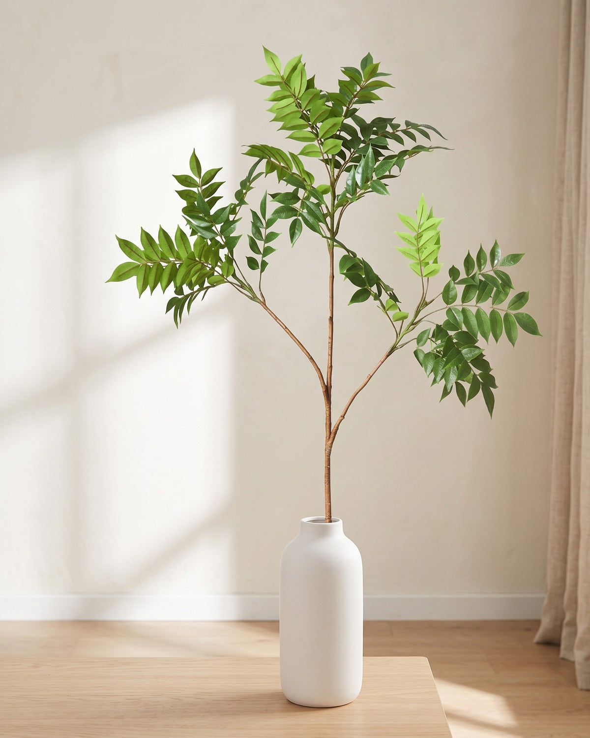 Feather leaf artificial tree branch, 3 stems, 47.2 in, standing in a plain white vase on a pale oak table; no vase is included